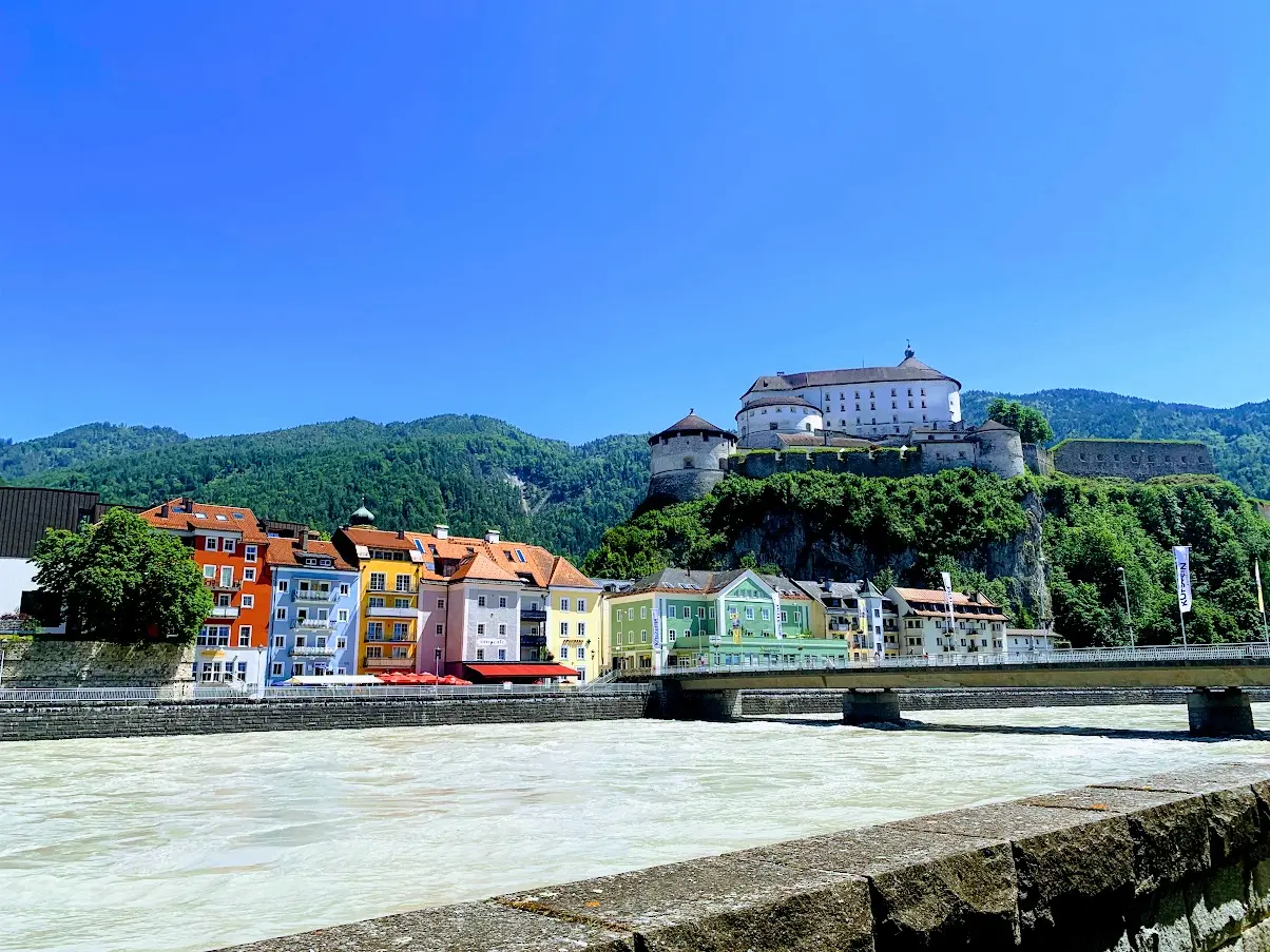Colourful houses along the Inn with Kufstein Fortress on a rock above them