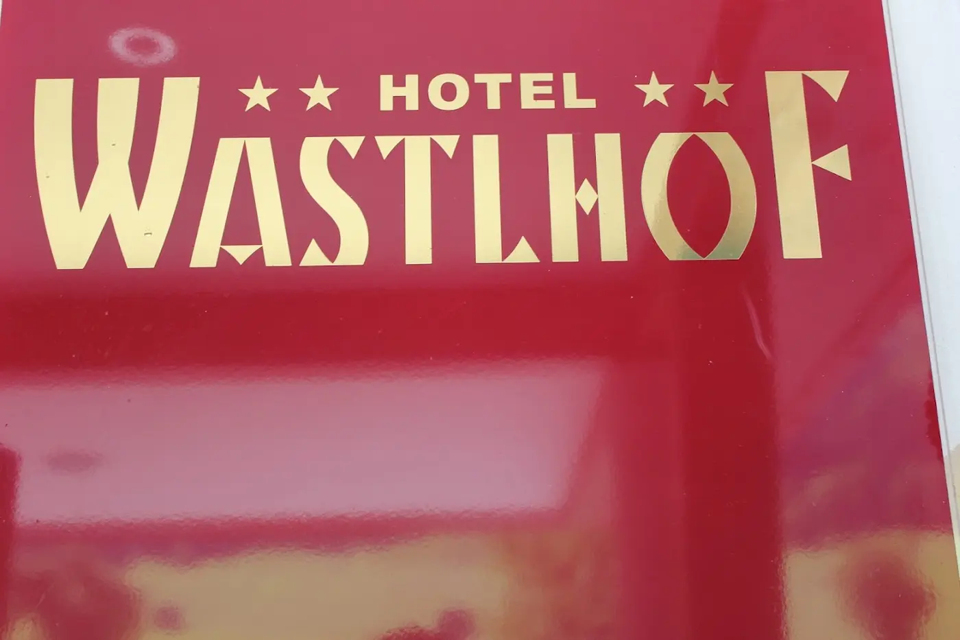 Red sign with gold lettering of Hotel Wastlhof